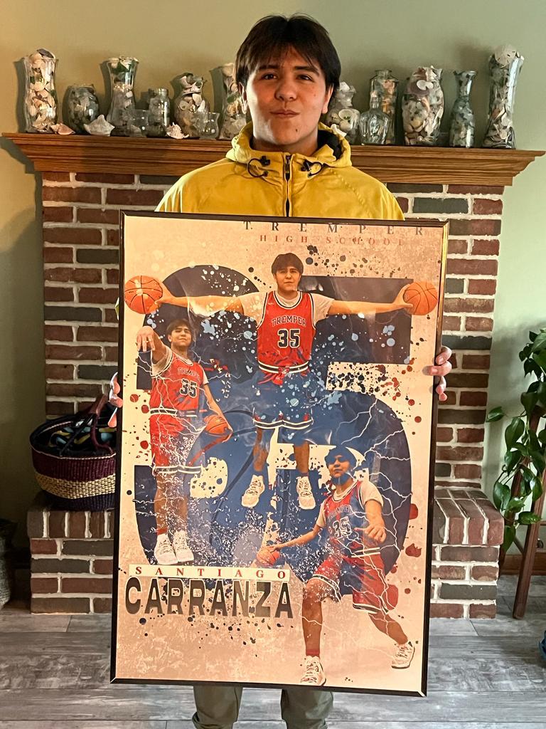 Santi holding his poster from his basketball season