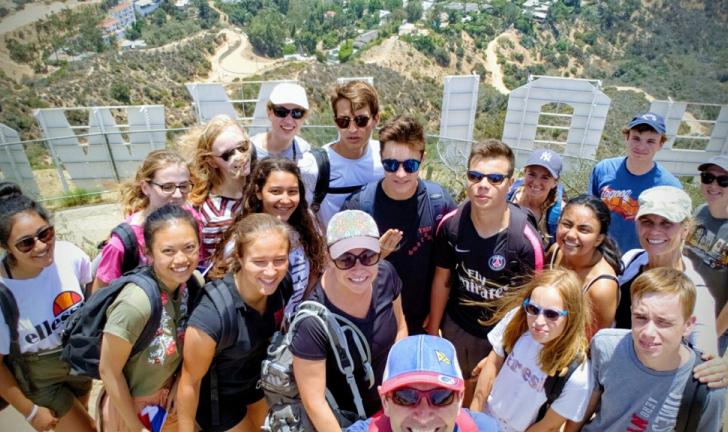 Group photos behind Hollywood sign