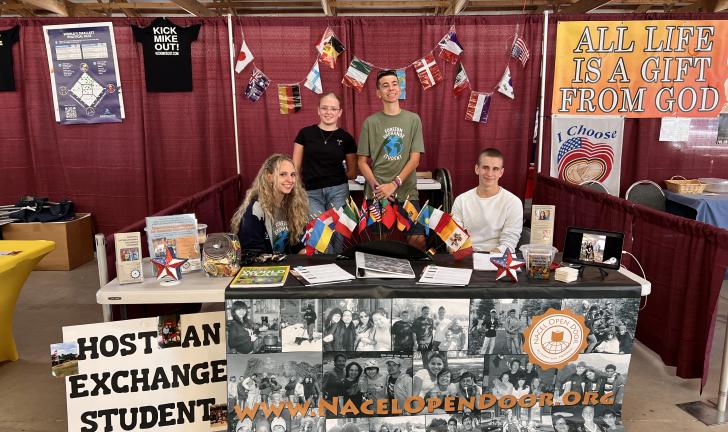 Didi's kids promoting student exchange at an info booth