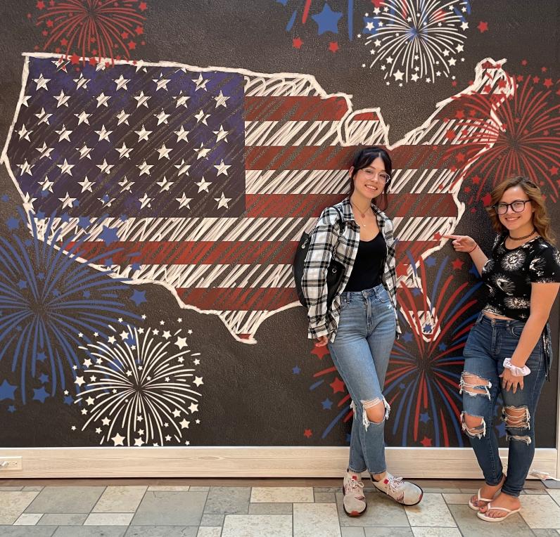 Girls in front of a Stars and Strip U.S. Map